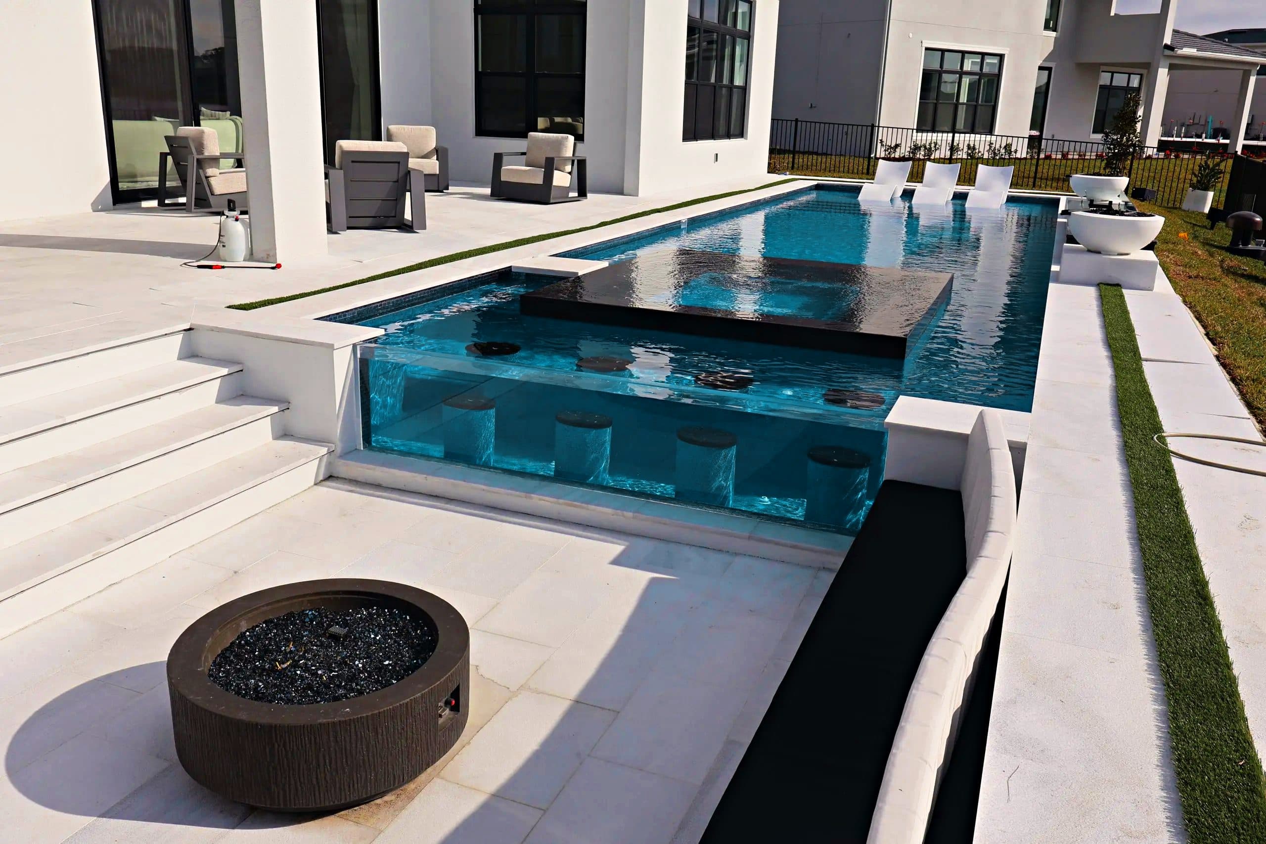 Finished luxury pool with spa and glass tile by D&J