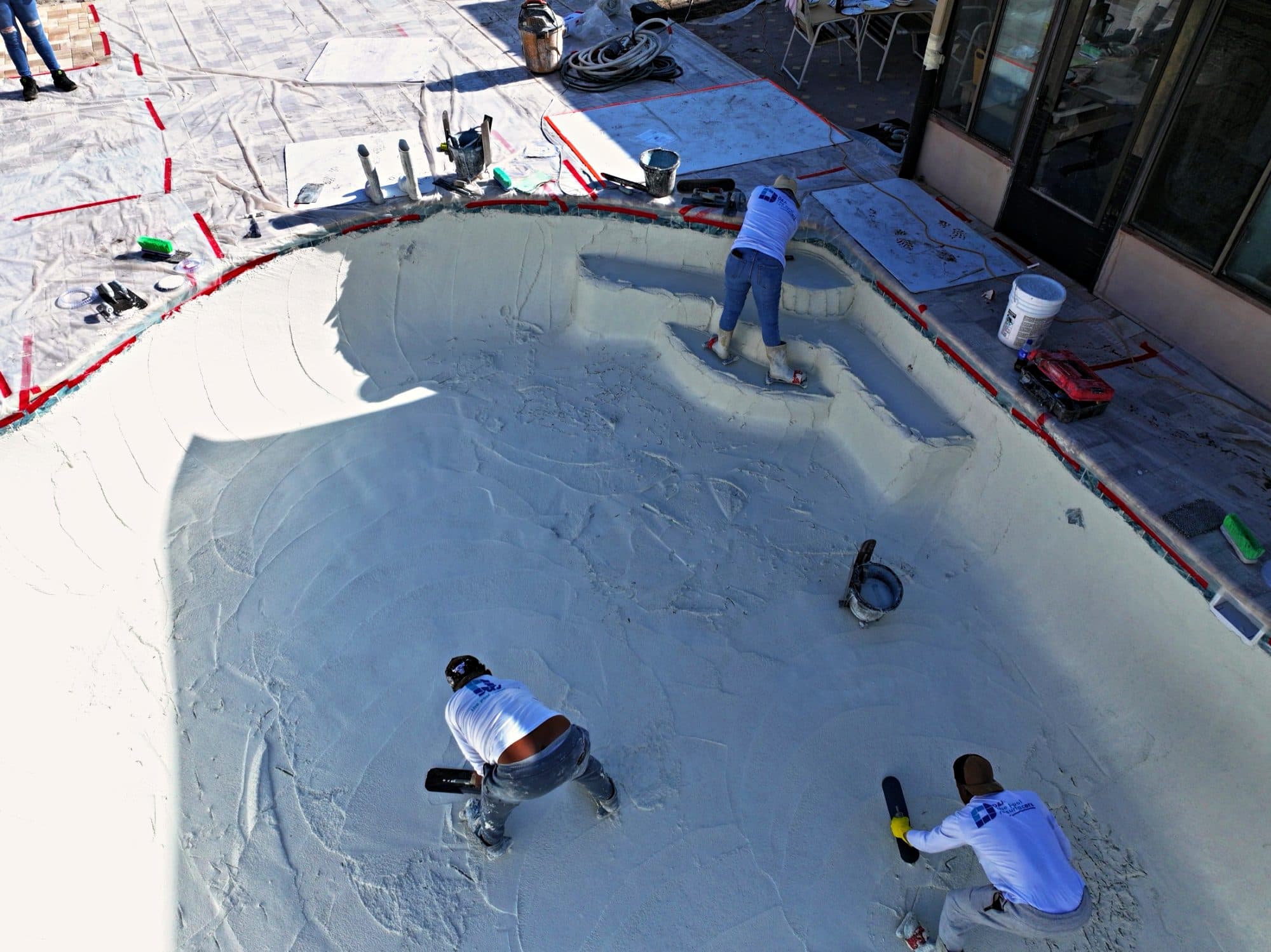 Aerial view of the crew smoothing a white finish