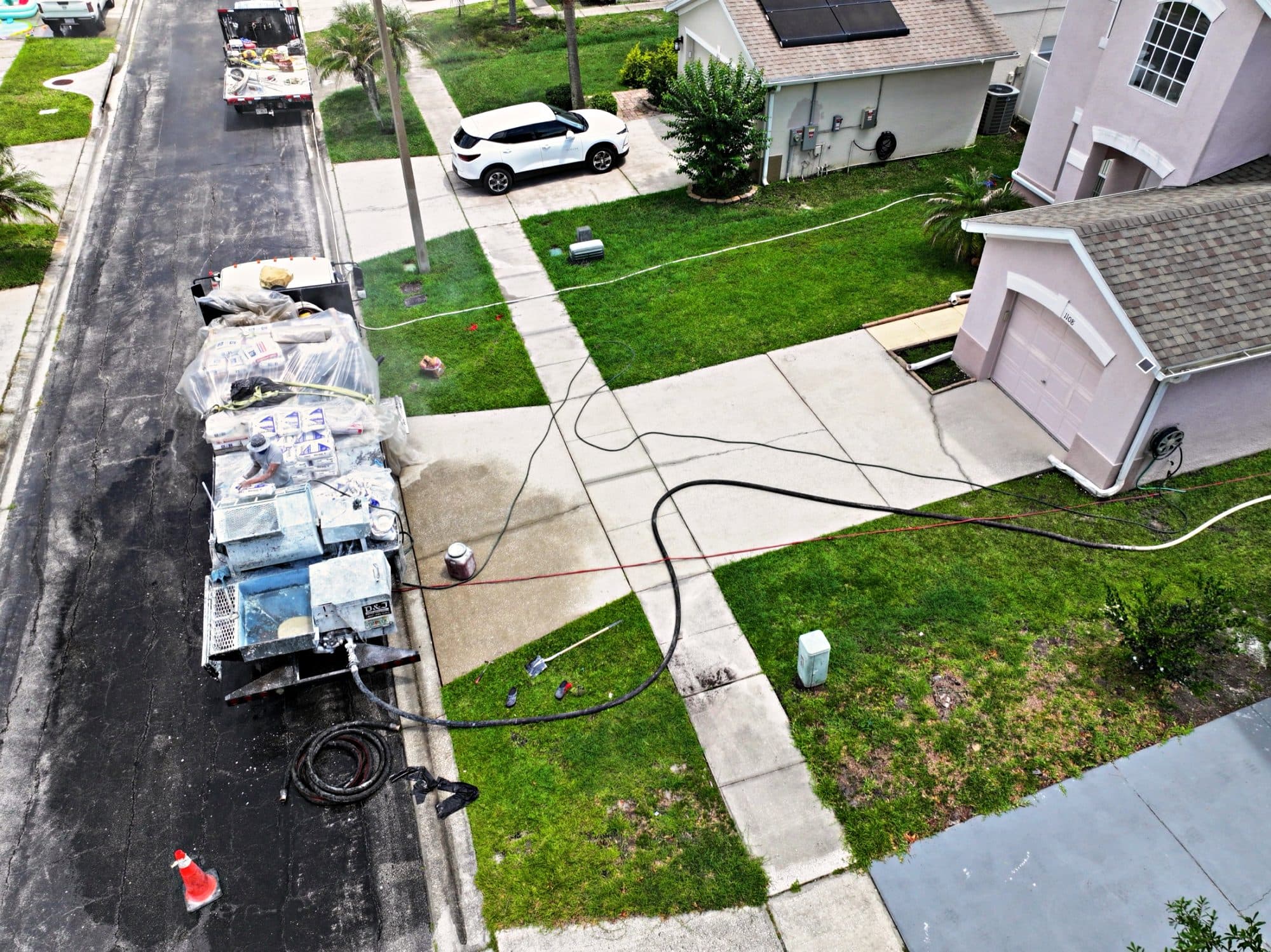 Aerial view: truck, hoses and a pool being finished